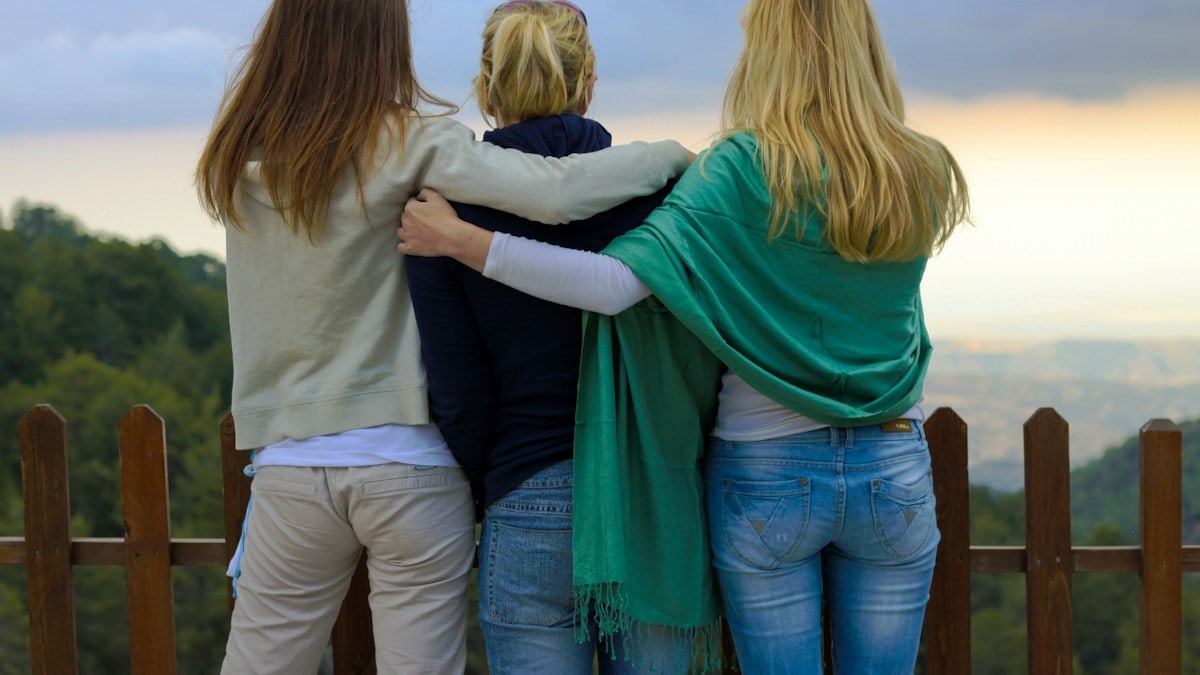a group of three women standing next to each other